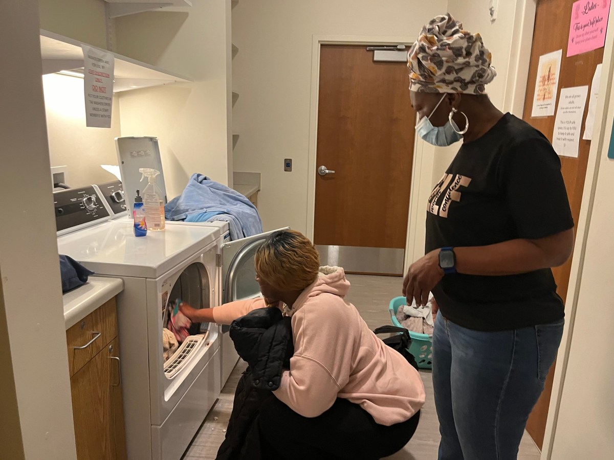 A woman loads laundry at the Benedict Center’s North Avenue drop-in center. The drop-in centers had more than 4,000 visitors in 2024.